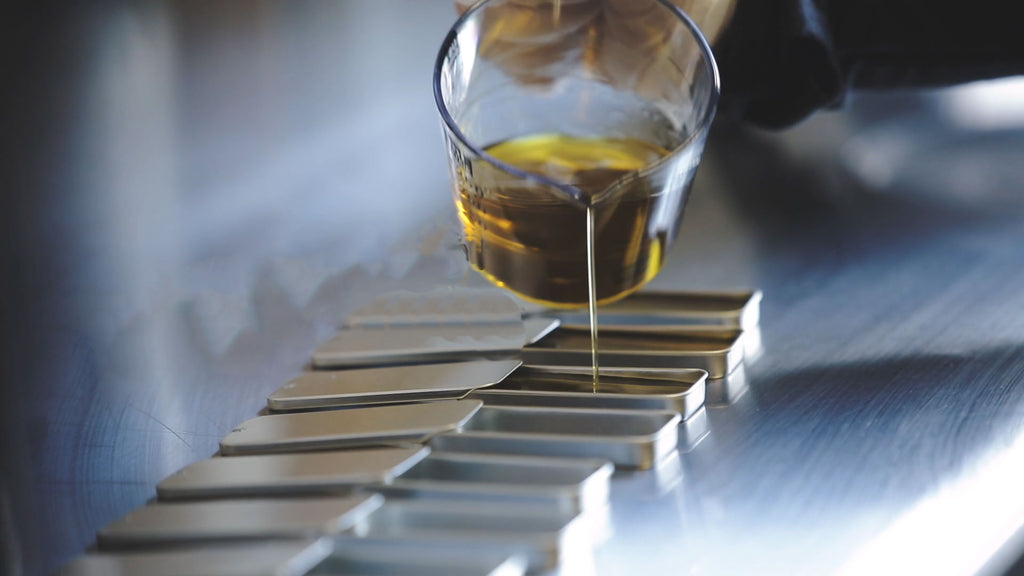 Pouring lip balm in the JAVA skin care lab